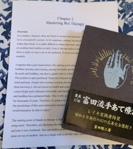Photo showing the original Reiki book by Kaiji Tomita and the english translation of chapter 2 by Dylan Luers Toda for Reiki Centers of America