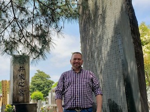 Photo of Brian Brunius at the memorial stone of Mikao Usui
